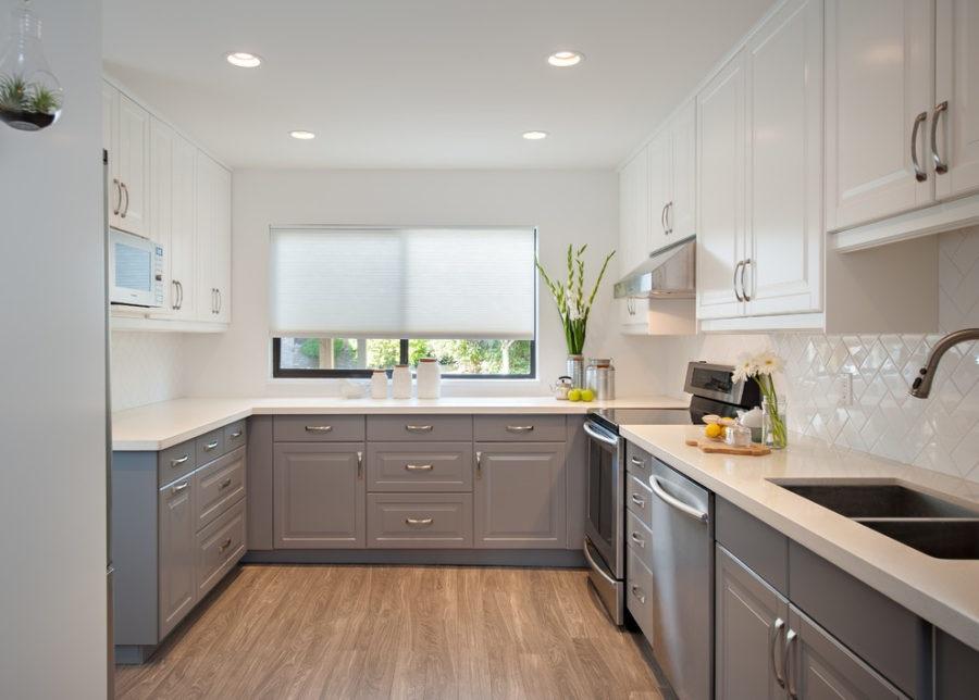 A kitchen with white cabinets and white counter tops Description automatically generated